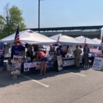 The Missoula County Republicans booth stretches across four tents at the 2026 Western Montana Fair as visitors talk with volunteers.