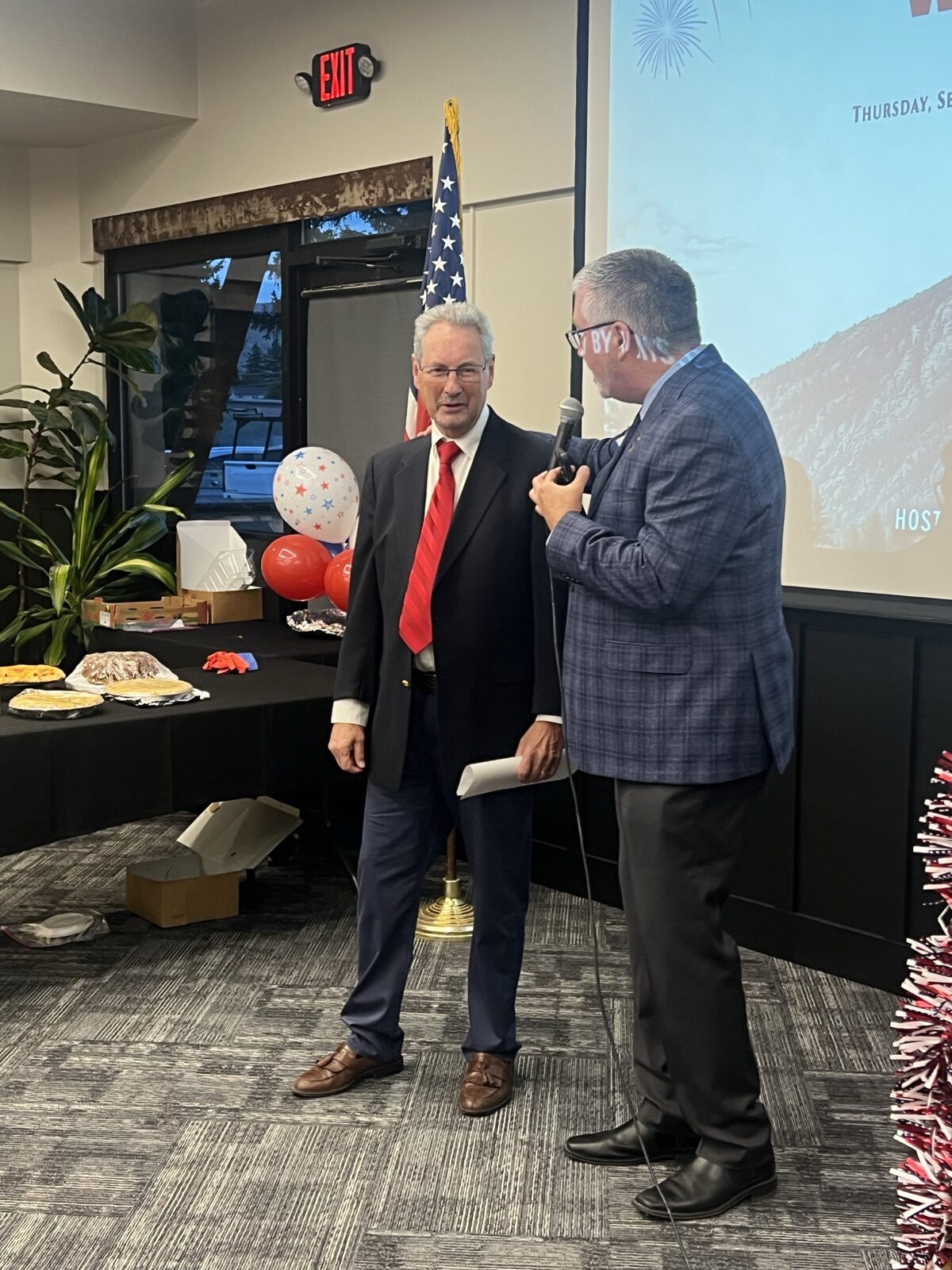 Chris Warden introduces keynote speaker Dan Happel on stage at Celebrate America.