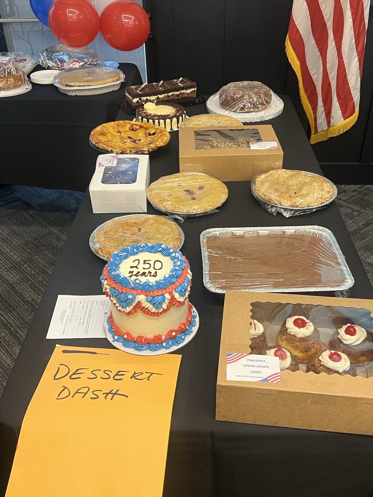 The Dessert Dash table, including a red, white, and blue cake marked 250 years.