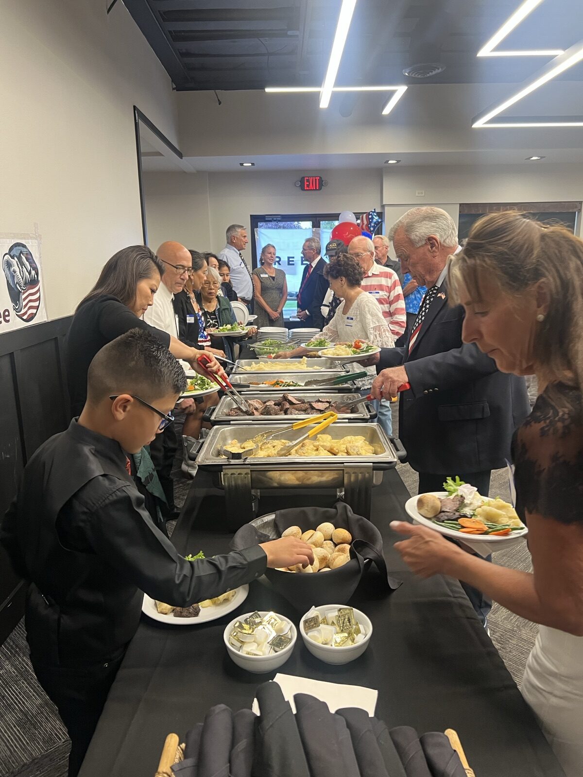 Guests go through the chicken and steak dinner line at Celebrate America.