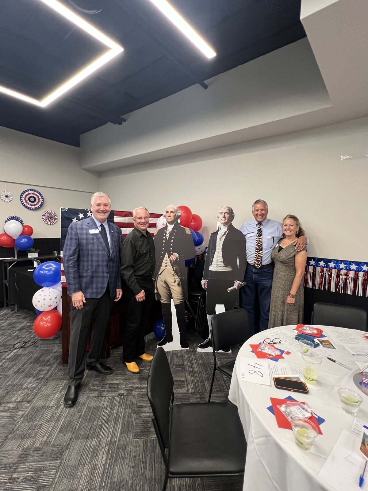Guests pose with George Washington and Founders cutouts, including emcee Chris Warden.