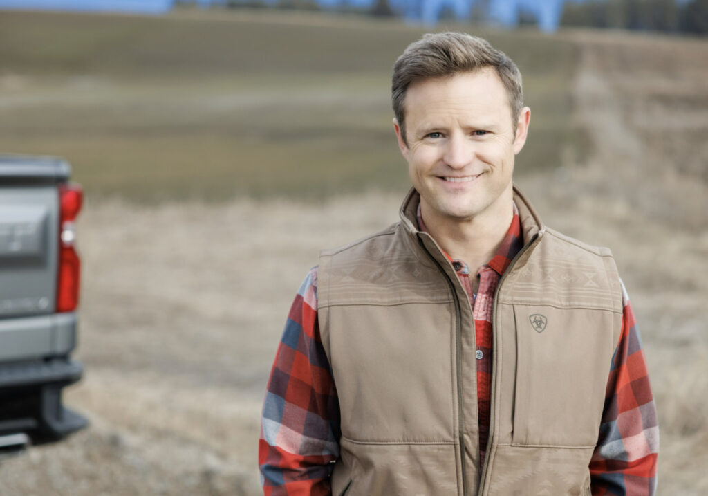 Aaron Flint, Republican nominee for Montana’s 1st Congressional District, standing in a Montana field.