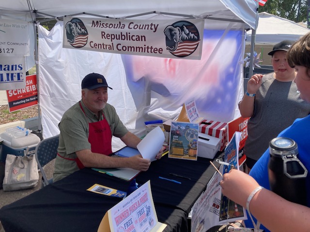 Volunteer signing up visitors at the Missoula GOP fair booth