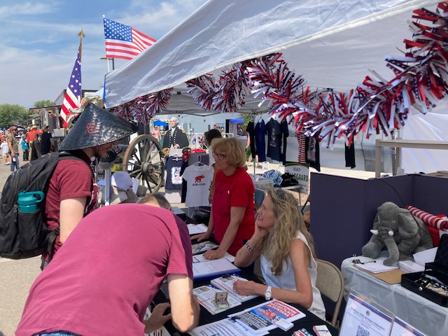 Volunteers talking with fairgoers at the Missoula GOP booth