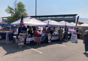 The Missoula County Republicans booth stretches across four tents at the 2026 Western Montana Fair as visitors talk with volunteers.