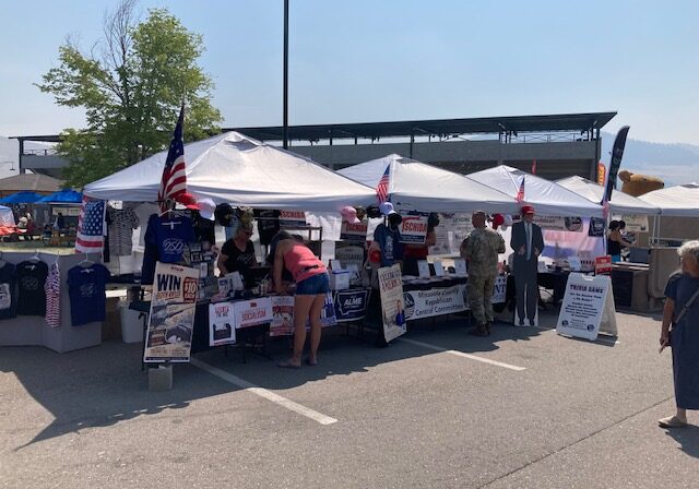 The Missoula County Republicans booth stretches across four tents at the 2026 Western Montana Fair as visitors talk with volunteers.